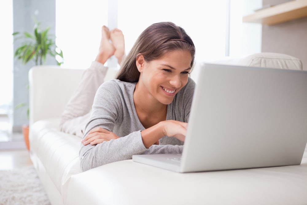 Young woman on the sofa chatting online