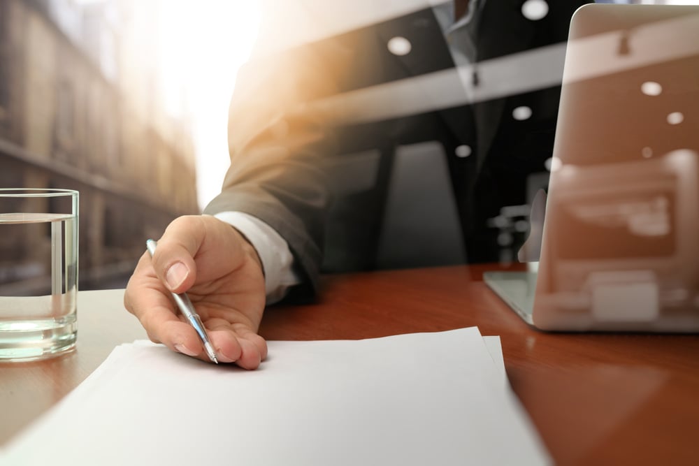 double exposure of businessman or salesman handing over a contract on wooden desk